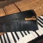 photo of piano key showing Damage from years of use