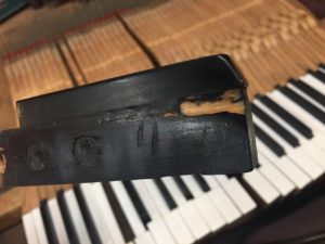 photo of piano key showing Damage from years of use