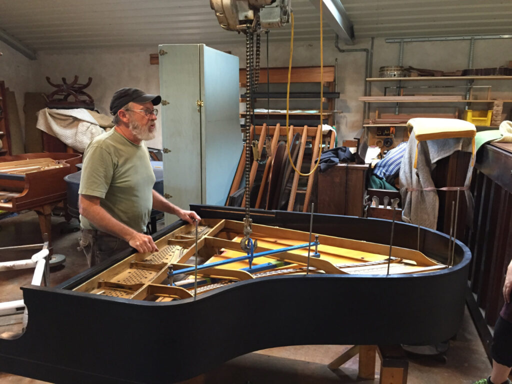Bernard Mollberg discussing a restoration project in his workshop.