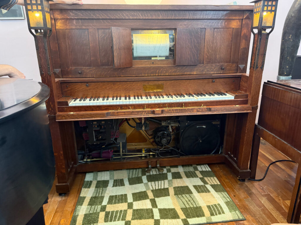 Duo-Art Gershwin reproducing piano with a Rhapsody in Blue roll loaded and the pneumatic mechanism exposed.